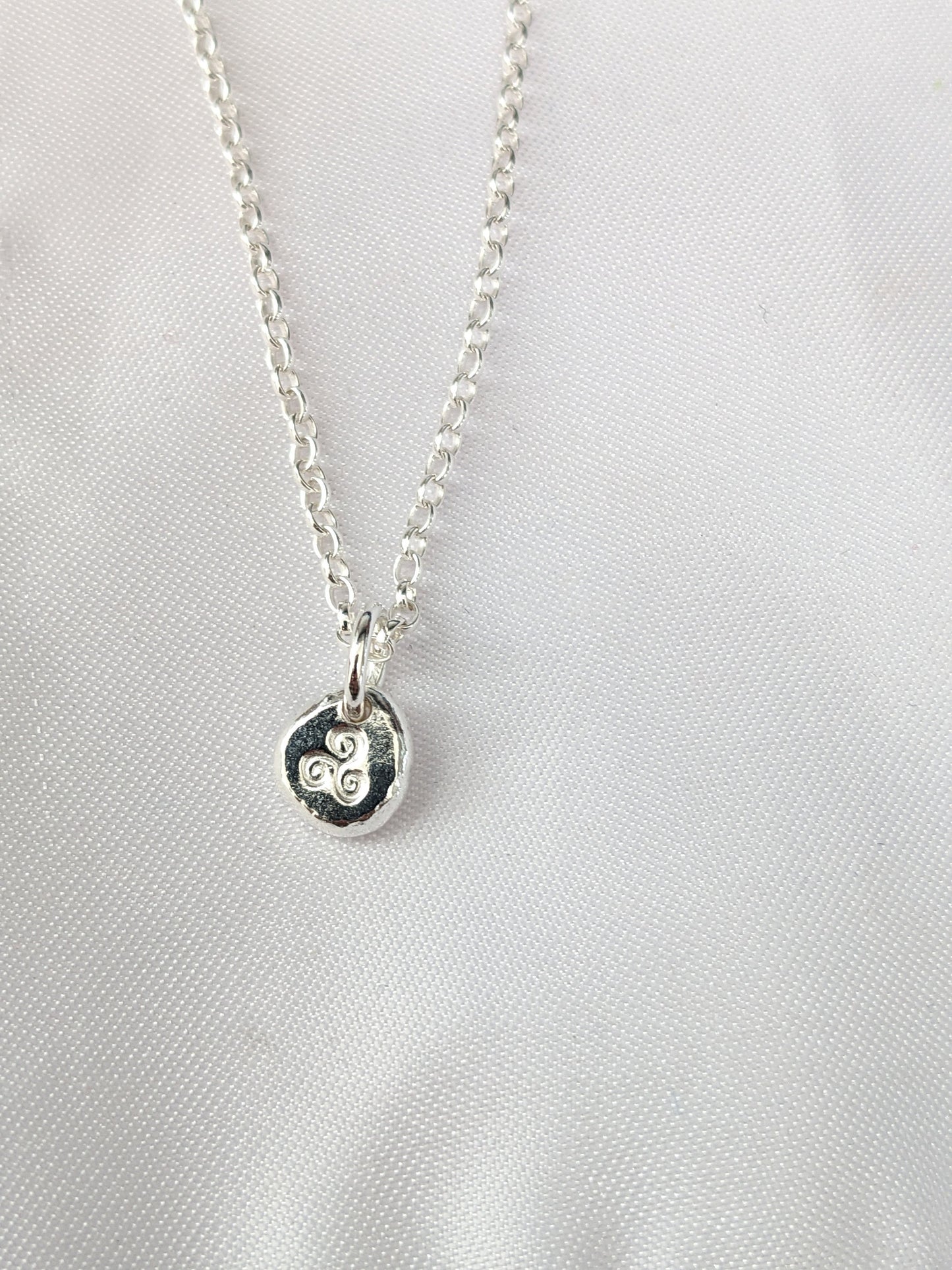Dainty sterling silver swirl triskele pendant | Organic shaped triskele pebble necklace