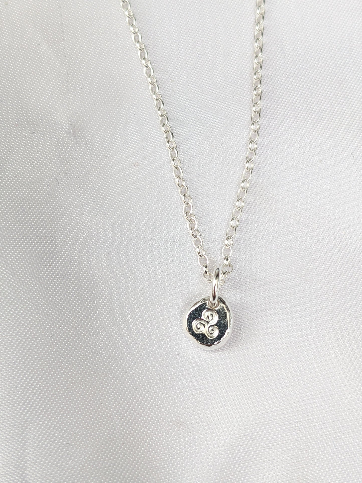 Dainty sterling silver swirl triskele pendant | Organic shaped triskele pebble necklace