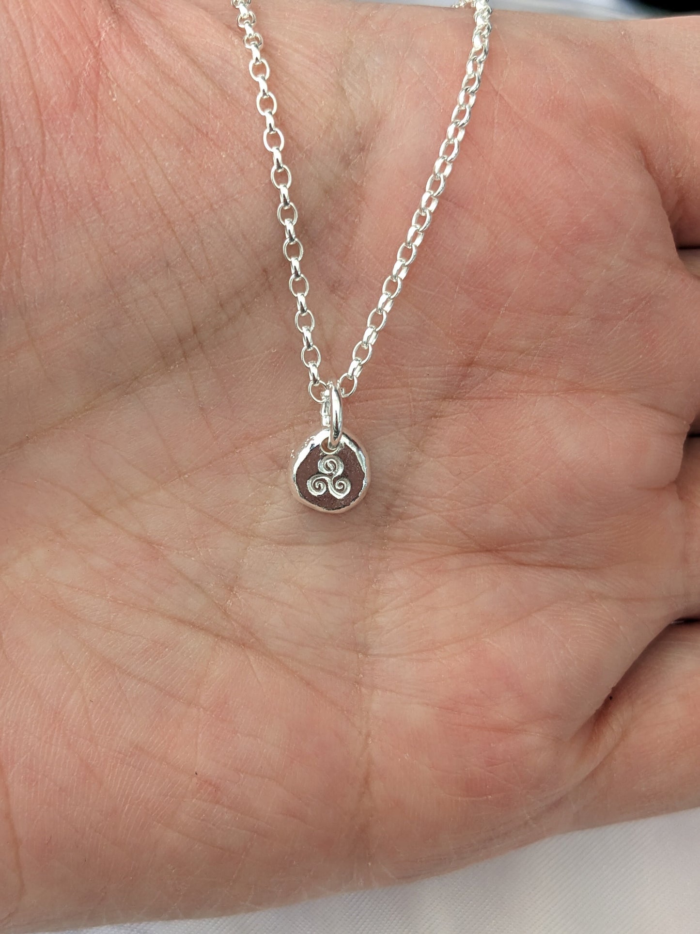 Dainty sterling silver swirl triskele pendant | Organic shaped triskele pebble necklace