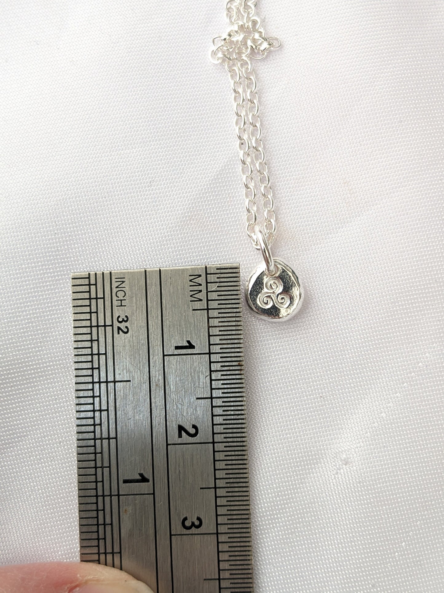 Dainty sterling silver swirl triskele pendant | Organic shaped triskele pebble necklace