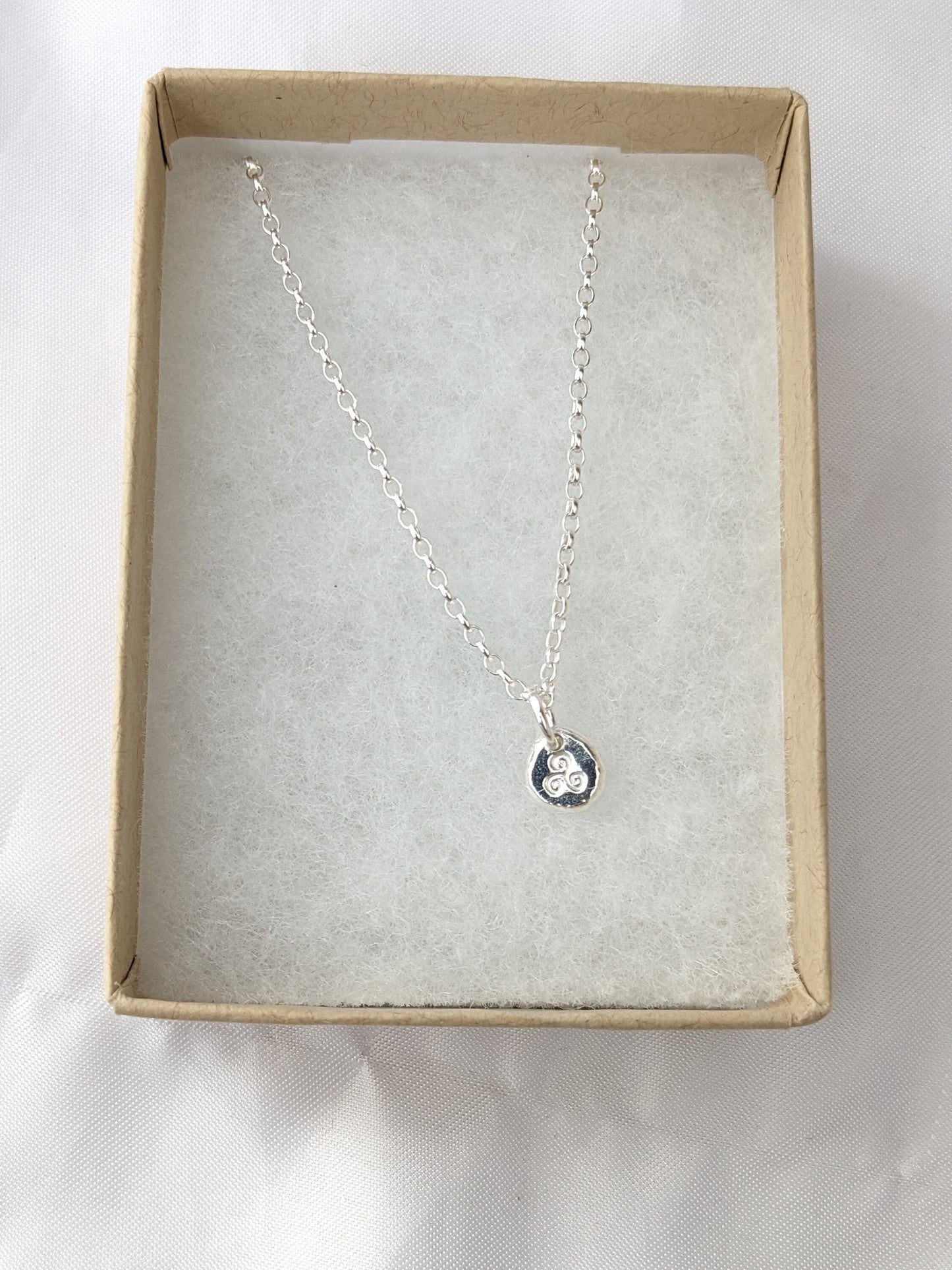 Dainty sterling silver swirl triskele pendant | Organic shaped triskele pebble necklace