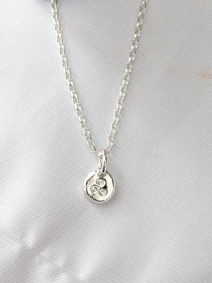Dainty sterling silver swirl triskele pendant | Organic shaped triskele pebble necklace