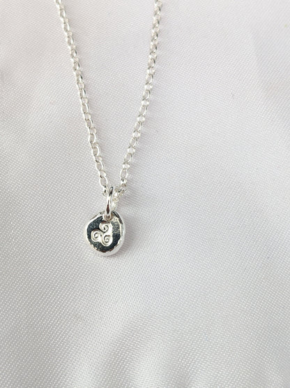 Dainty sterling silver swirl triskele pendant | Organic shaped triskele pebble necklace