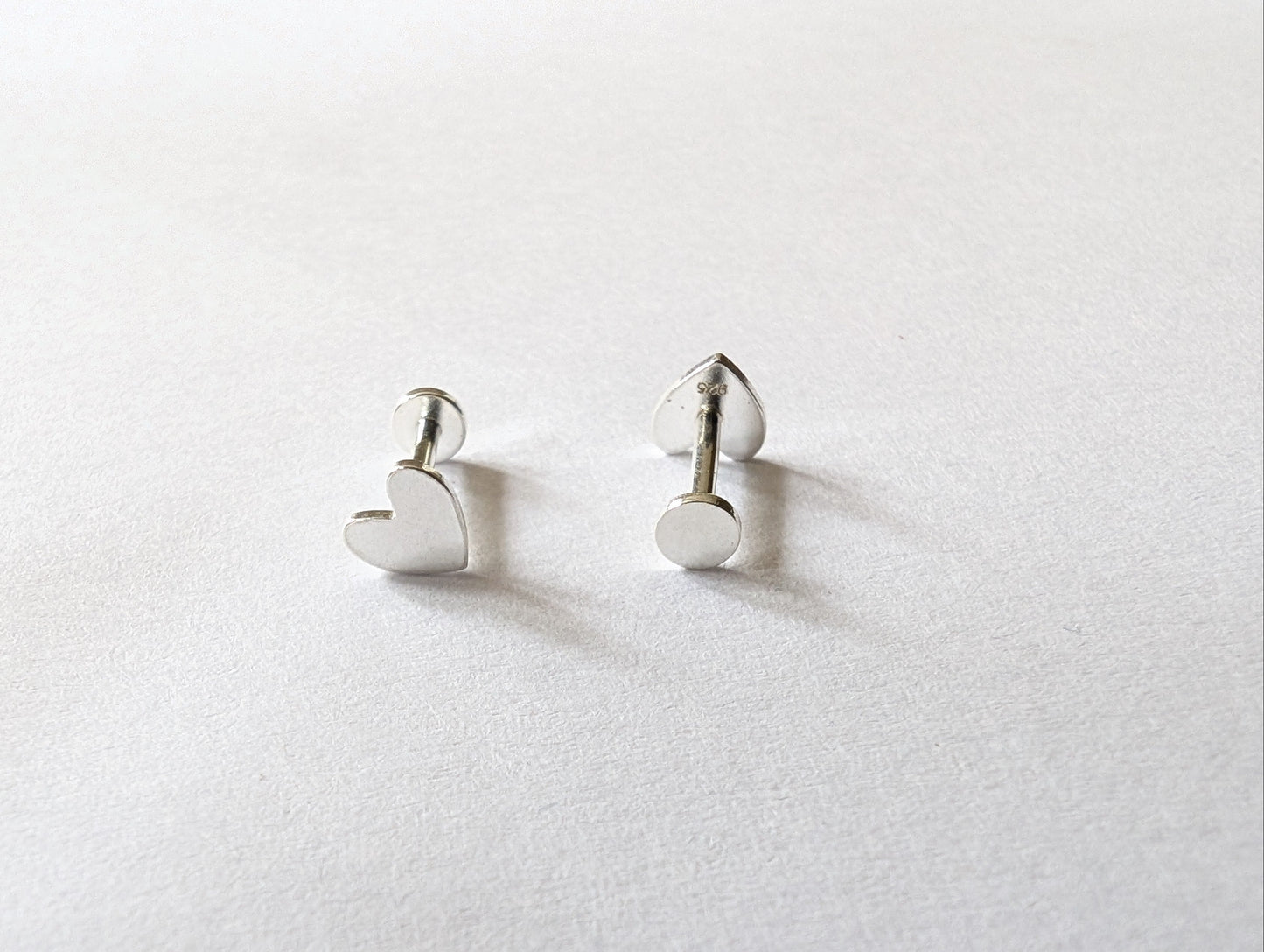 Front and back of sterling silver heart labret earrings