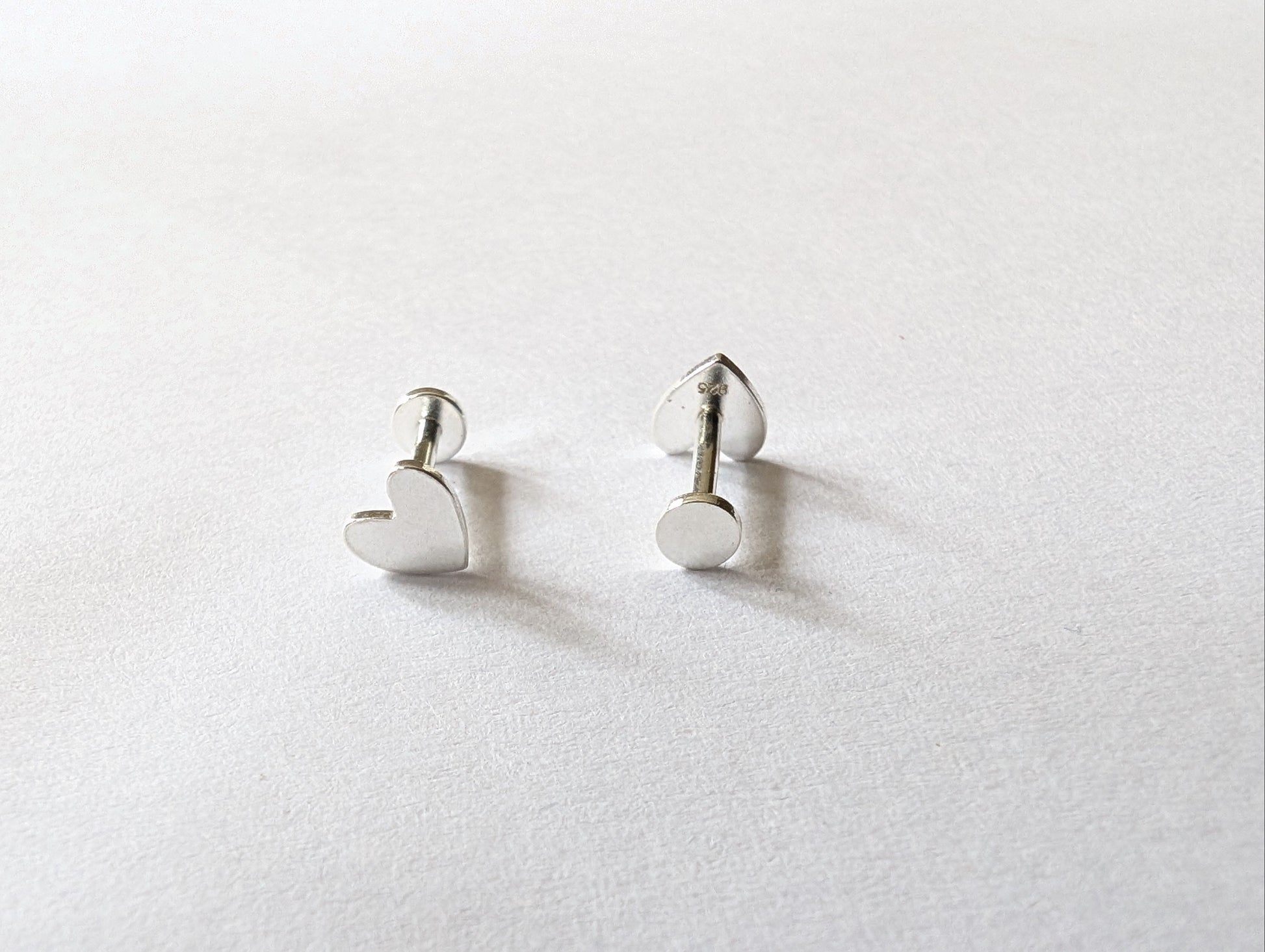 Front and back of sterling silver heart labret earrings