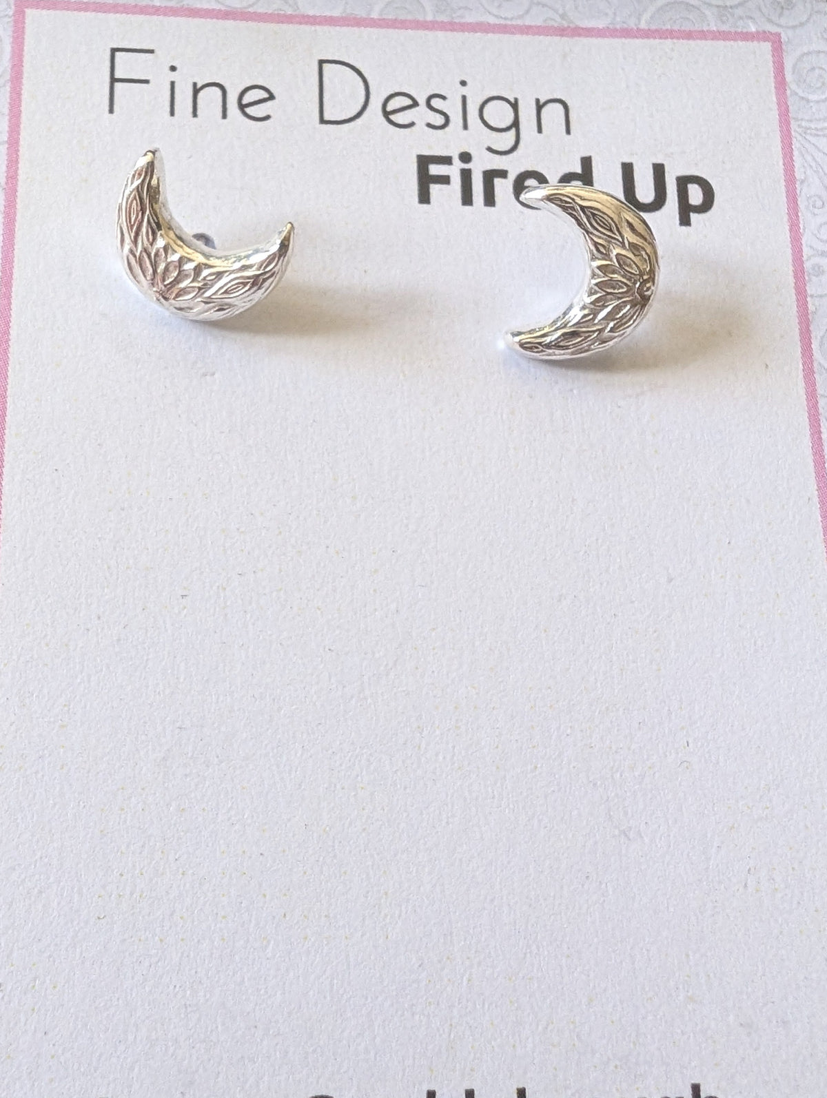 Sterling silver crescent moon handmade stud earrings on backing card