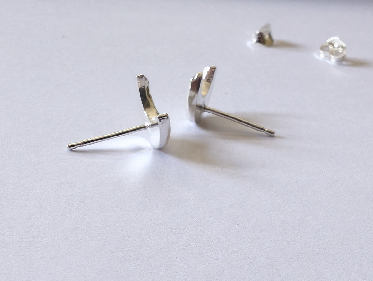 side view of the sterling silver crescent moon stud earrings to demonstrate thickness