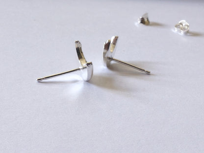 side view of the sterling silver crescent moon stud earrings to demonstrate thickness